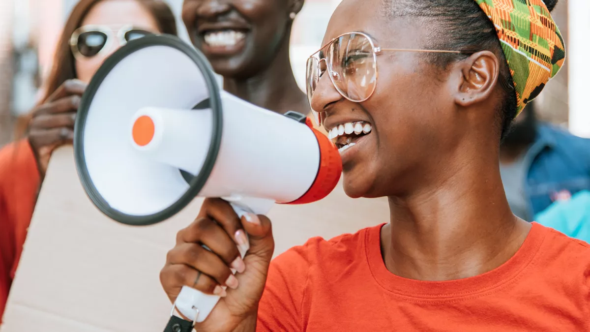 Girl with megaphone in a group of people