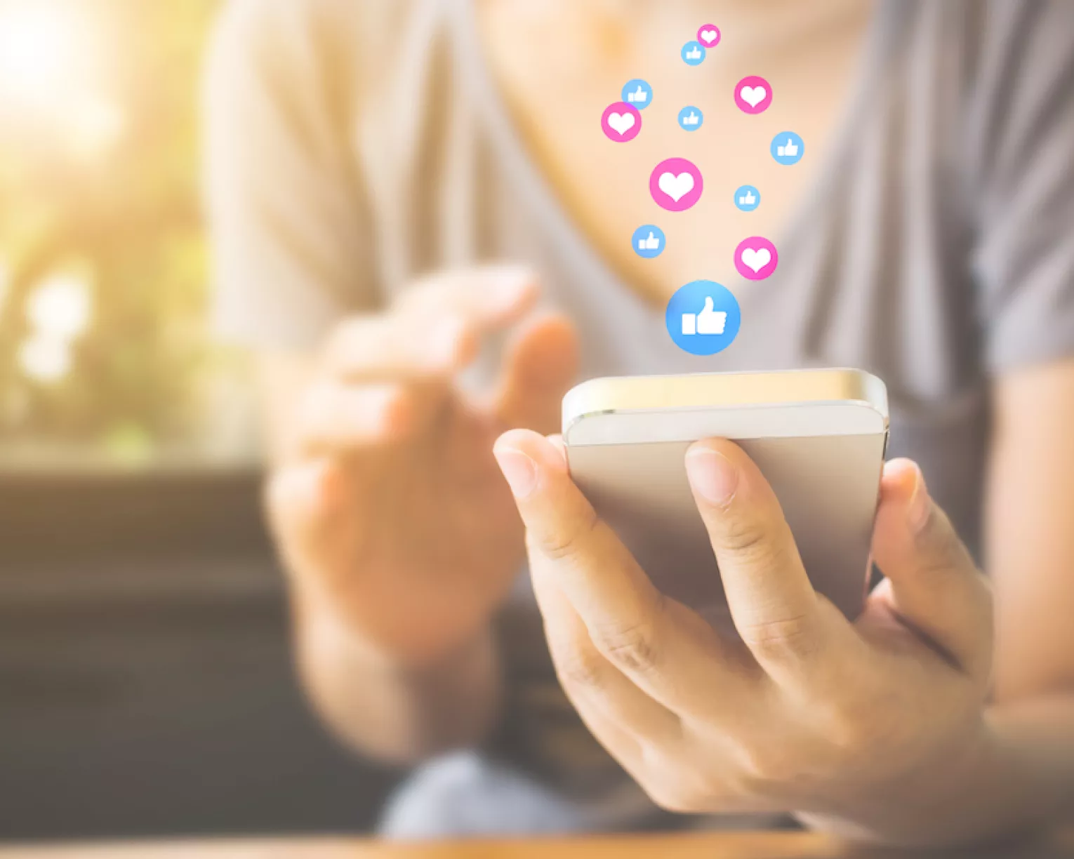 A woman uses her phone to post on Facebook
