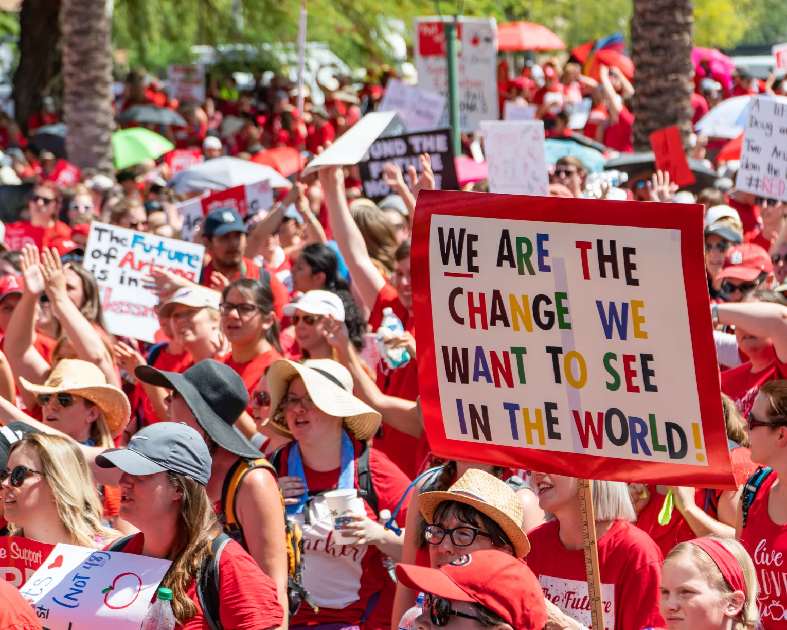 "We are the change we want to see in the world" sign at RedForEd rally