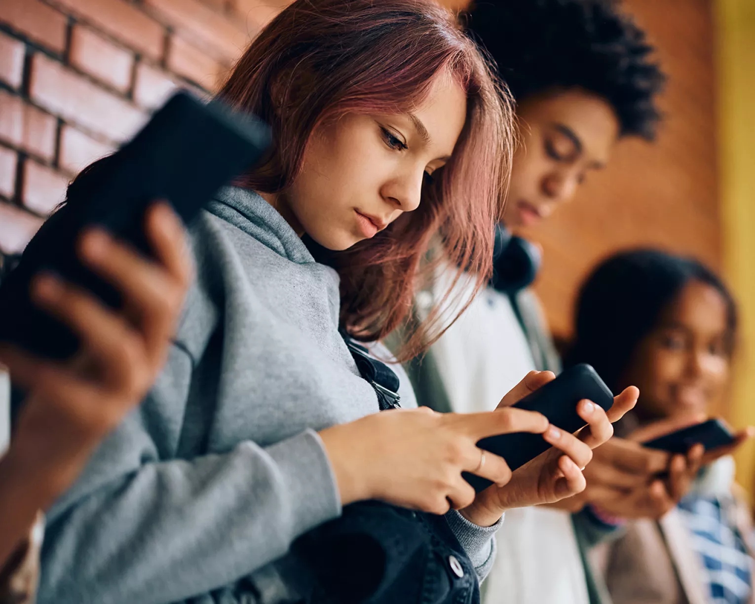 students on cell phones in hall